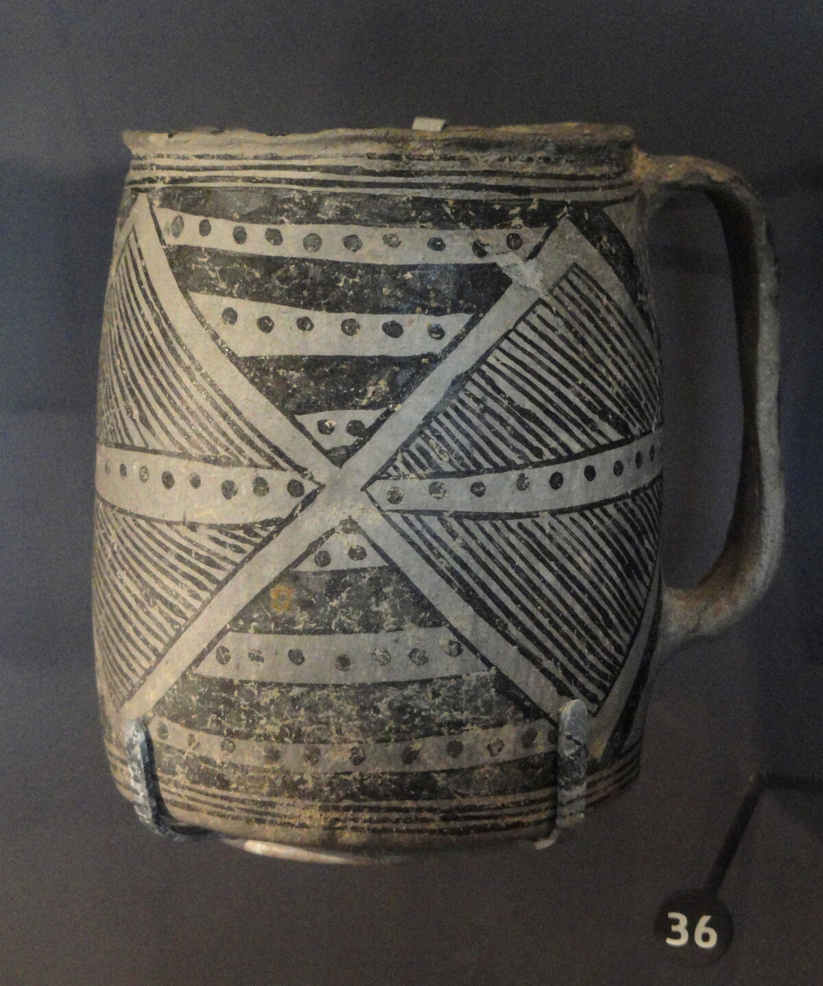 Anasazi ceramic bowl and mug decorated with black geometric patterns on a white ground