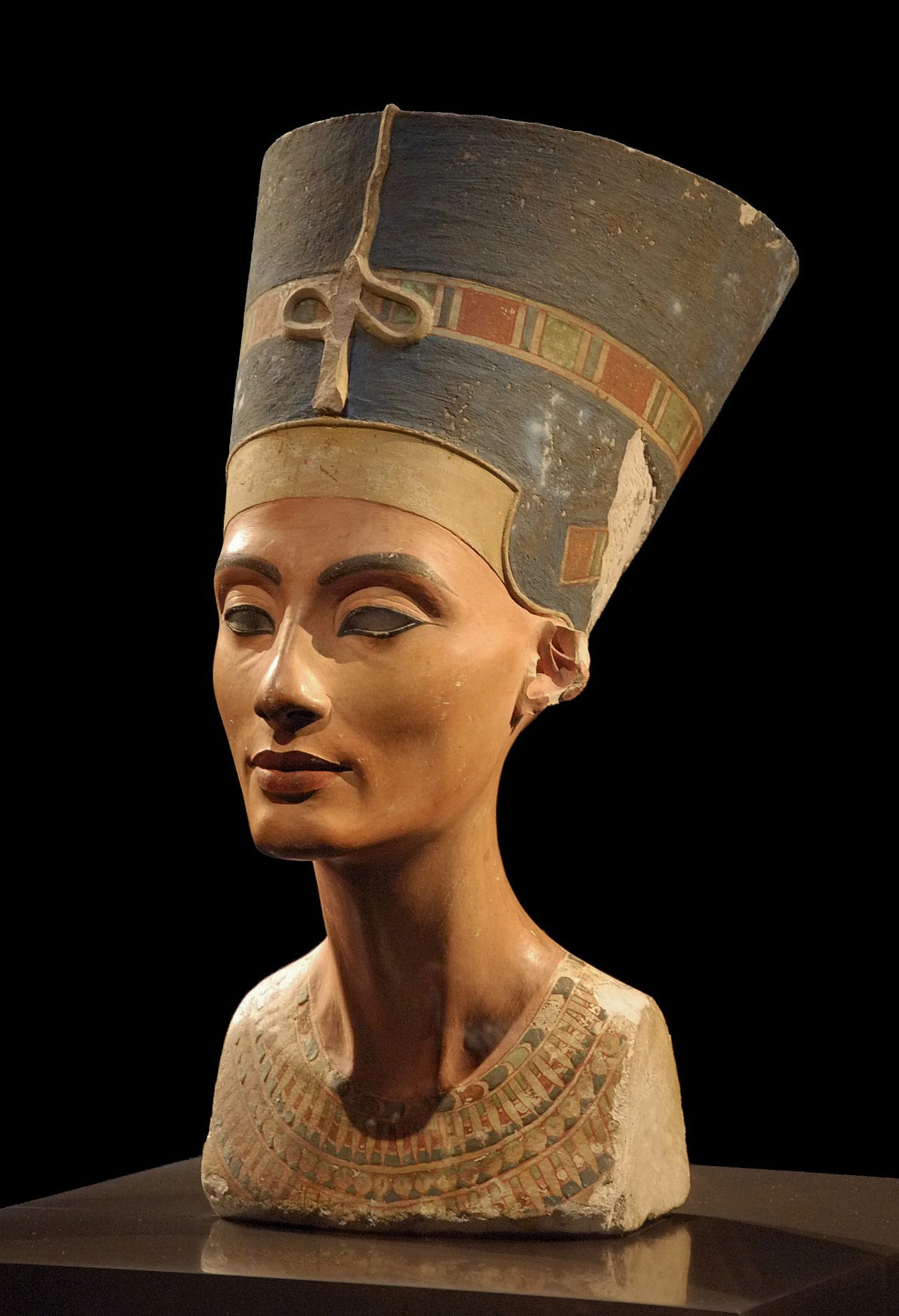 Painted bust of Queen Nefertiti wearing her blue crown, on display at the Neues Museum in Berlin