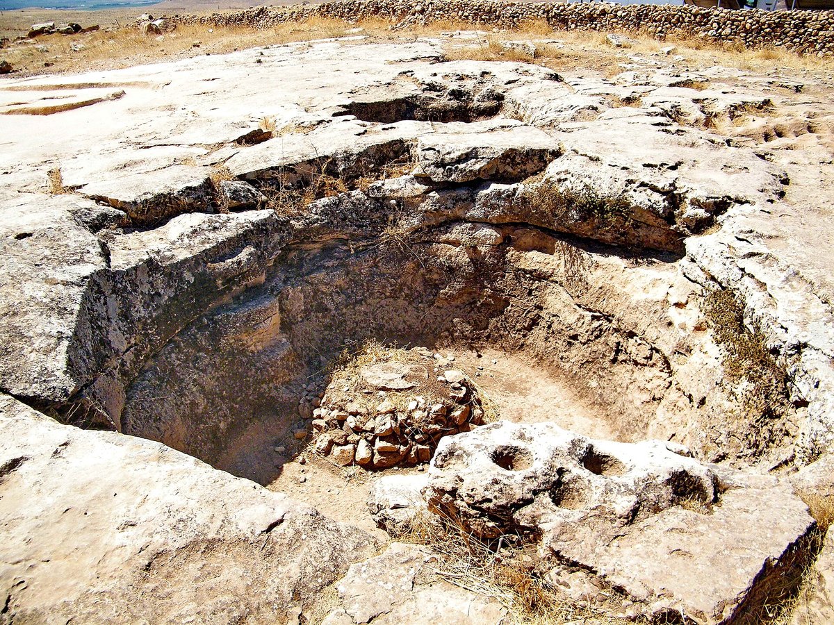 Grande cavité circulaire taillée dans la roche calcaire sur le plateau de Göbekli Tepe, interprétée comme une citerne